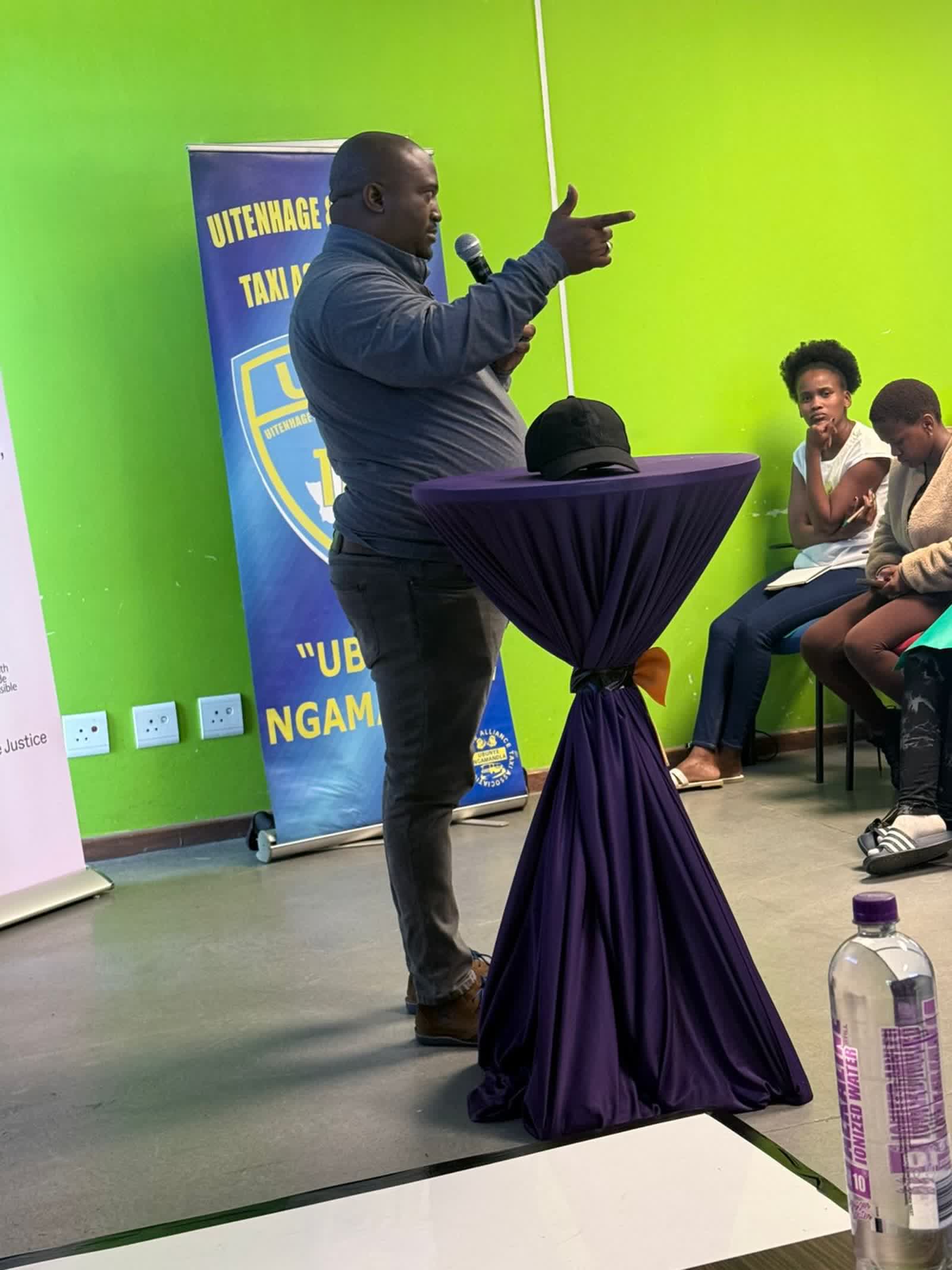 A speaker at the podium making a point